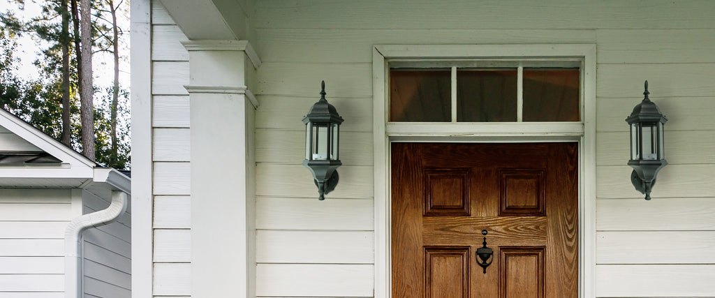Two Traditional Outdoor Light Fixtures mounted on each side of main entry door